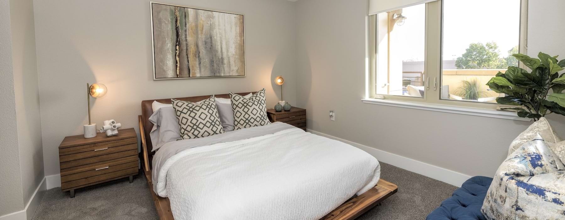 a bedroom with a bed and two nightstands