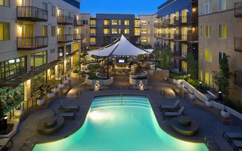 a pool in a courtyard between buildings