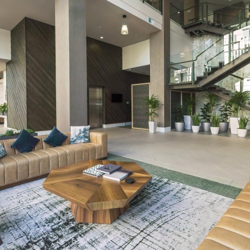a clubroom with couches, a table and a chair